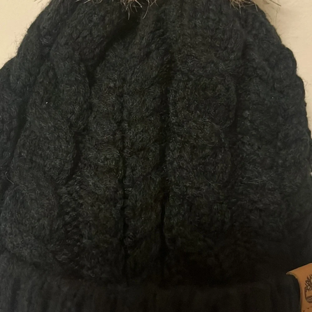 Timberland black cable knit, fleece lined hat with furry Pom on top, new